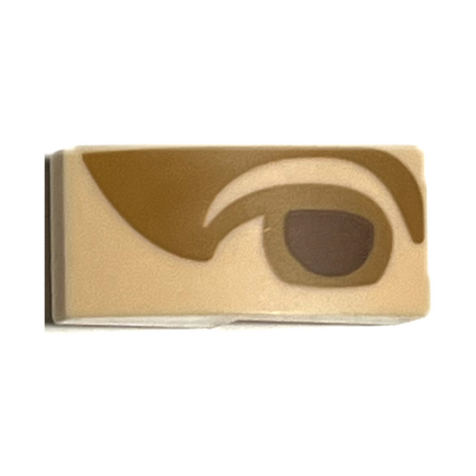 Light Nougat Slope, Curved 2 x 1 x 2/3 with Reddish Brown Right Eye with Medium Nougat Eyelid and Shadow Pattern (Mona Lisa)