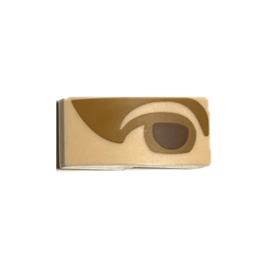 Light Nougat Slope, Curved 2 x 1 x 2/3 with Reddish Brown Right Eye with Medium Nougat Eyelid and Shadow Pattern Mona Lisa